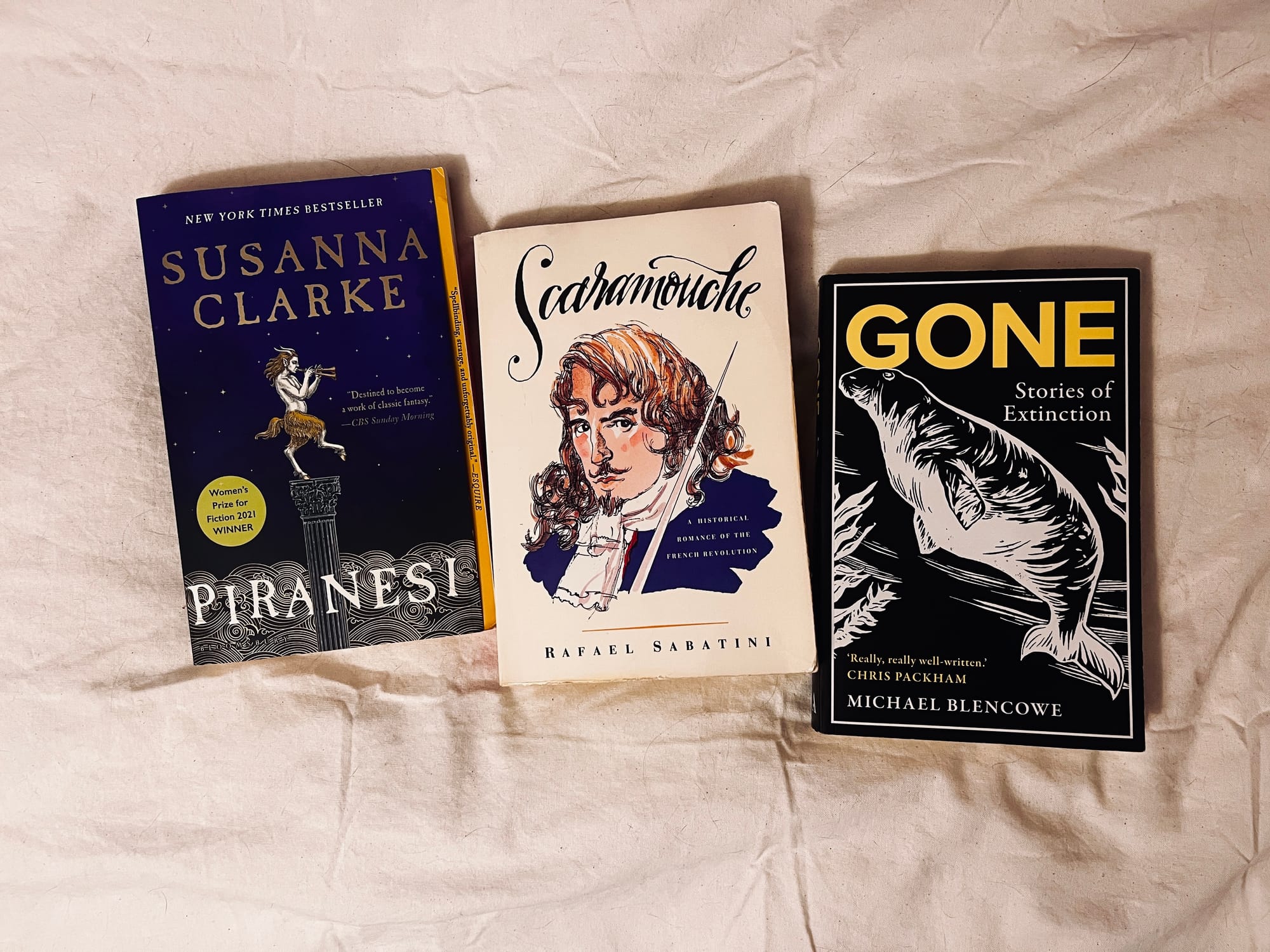 Three books laid out on my bed: Piranesi by Susana Clarke, Scaramouche by Rafael Sabatini and Gone by Michael Blencowe